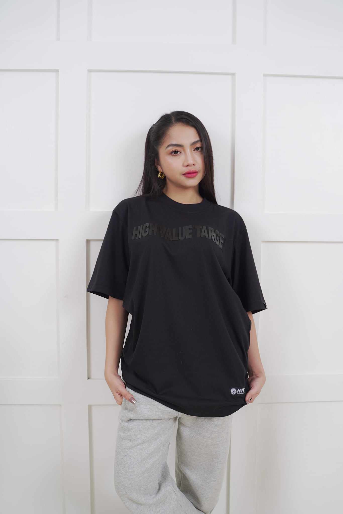 Black graphic T shirt with subtle lettering for modern and clean outfit combinations