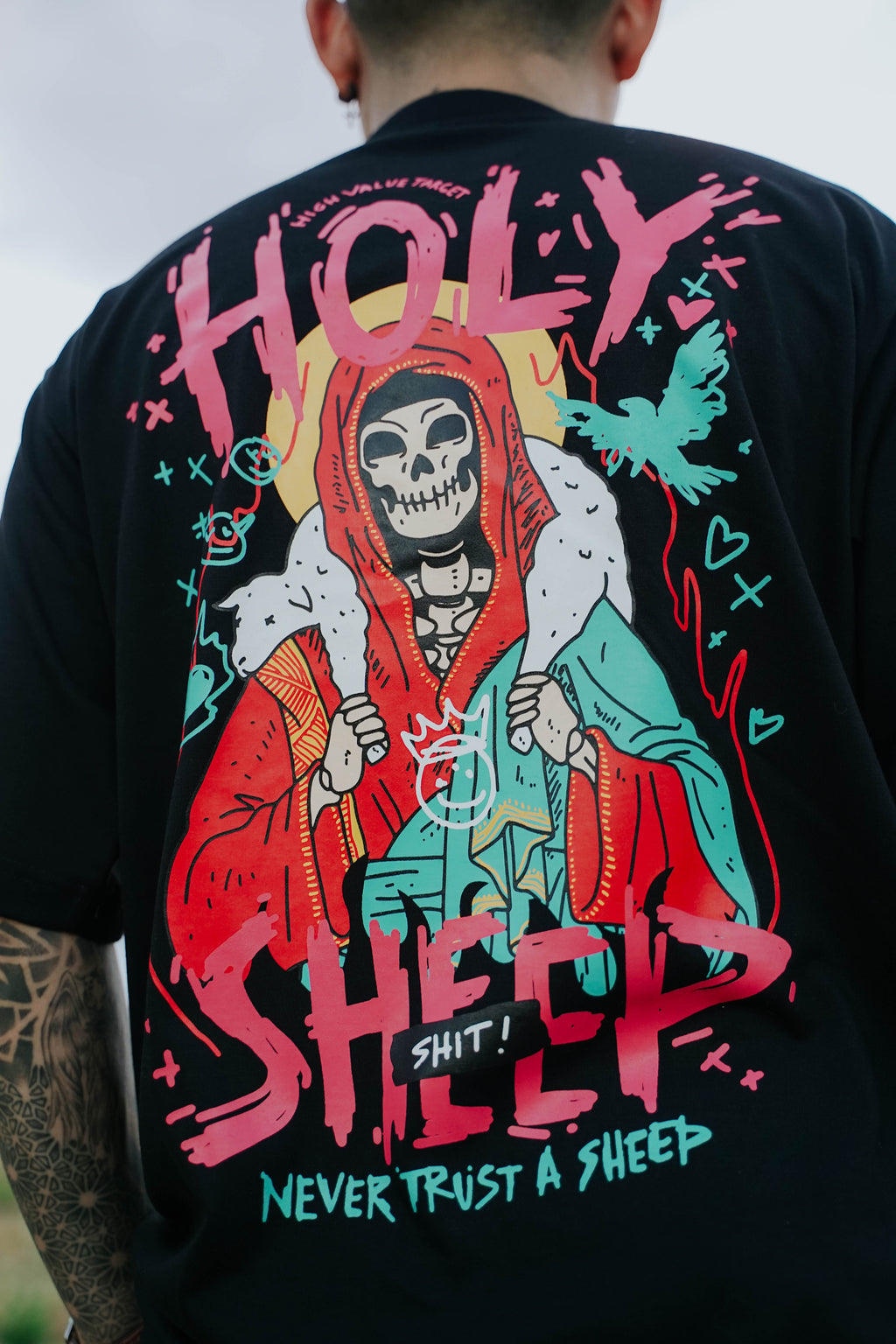 Streetwear shirt with skeleton and sheep illustration, dark humor concept with never trust the sheep front graphic