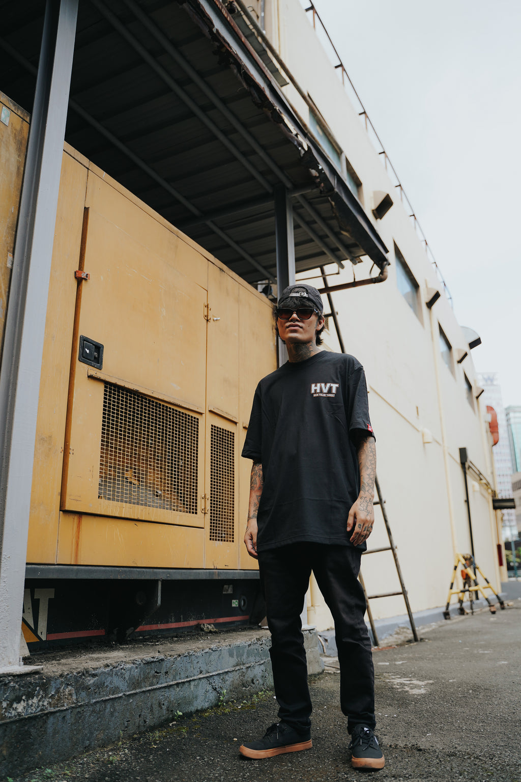 Minimalist black tee with HVT high value target logo on front, modern streetwear style simple chest graphic