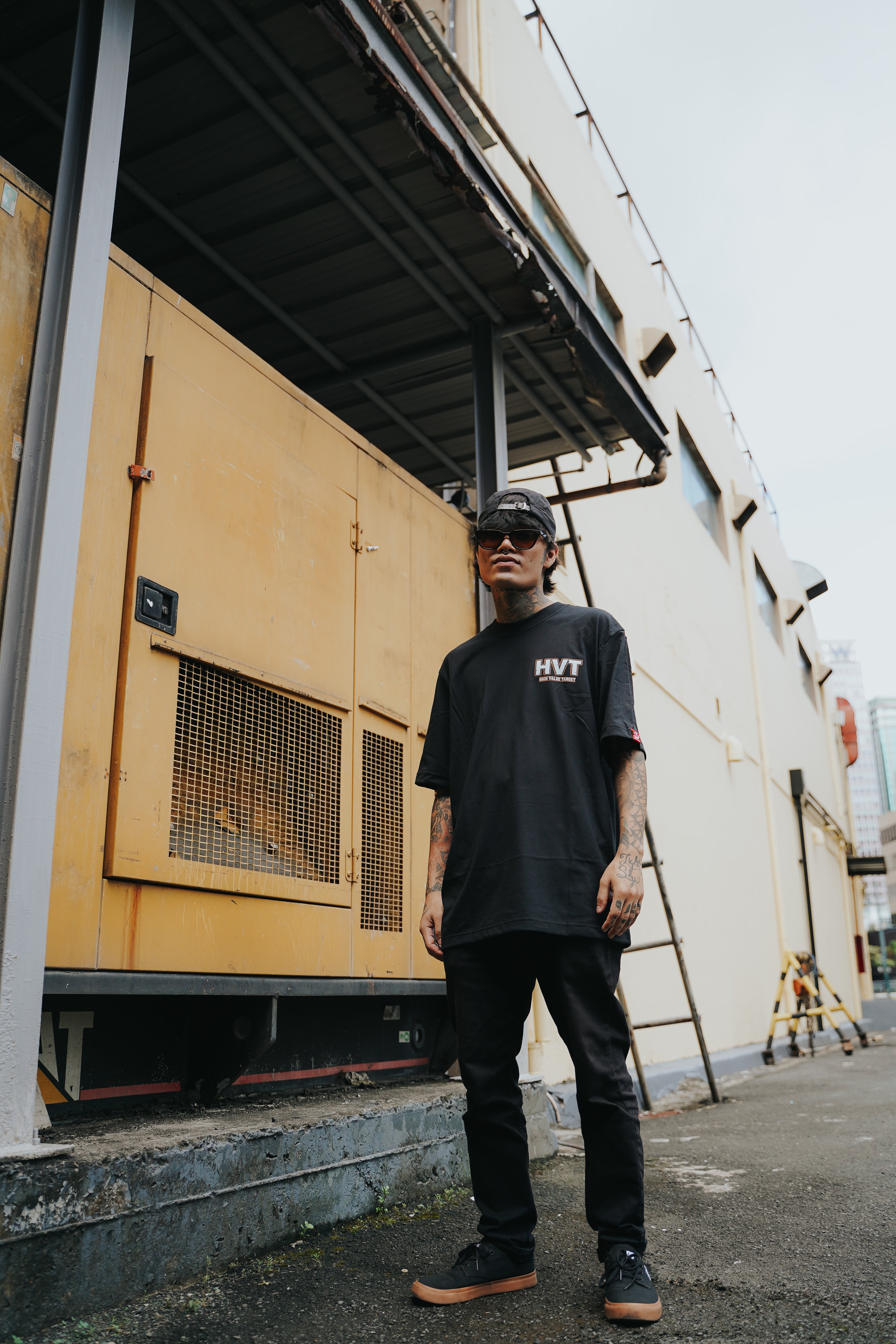 Minimalist black tee with HVT high value target logo on front, modern streetwear style simple chest graphic