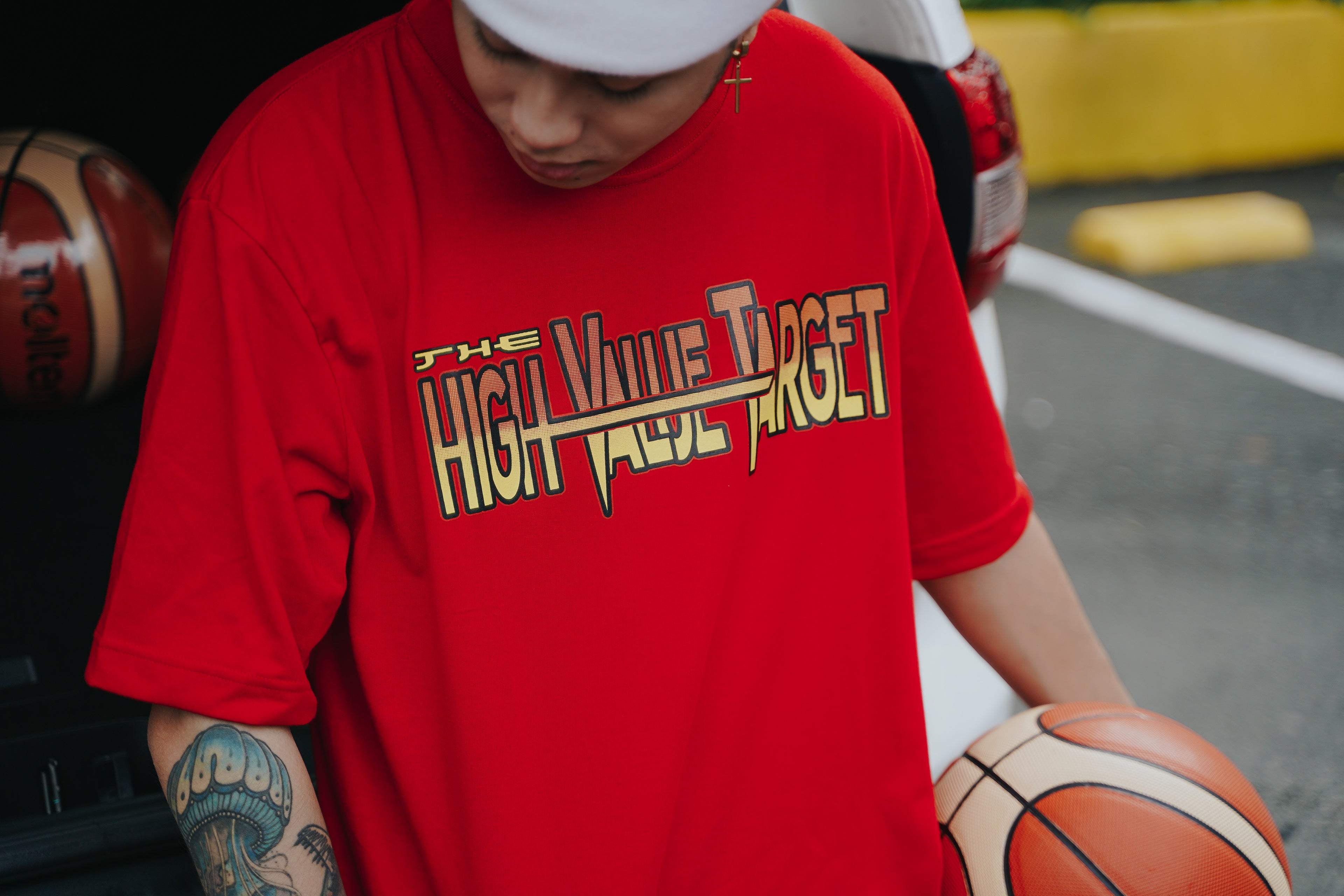 Red streetwear T shirt with HVT bold logo text and Rise and Grind motivational design