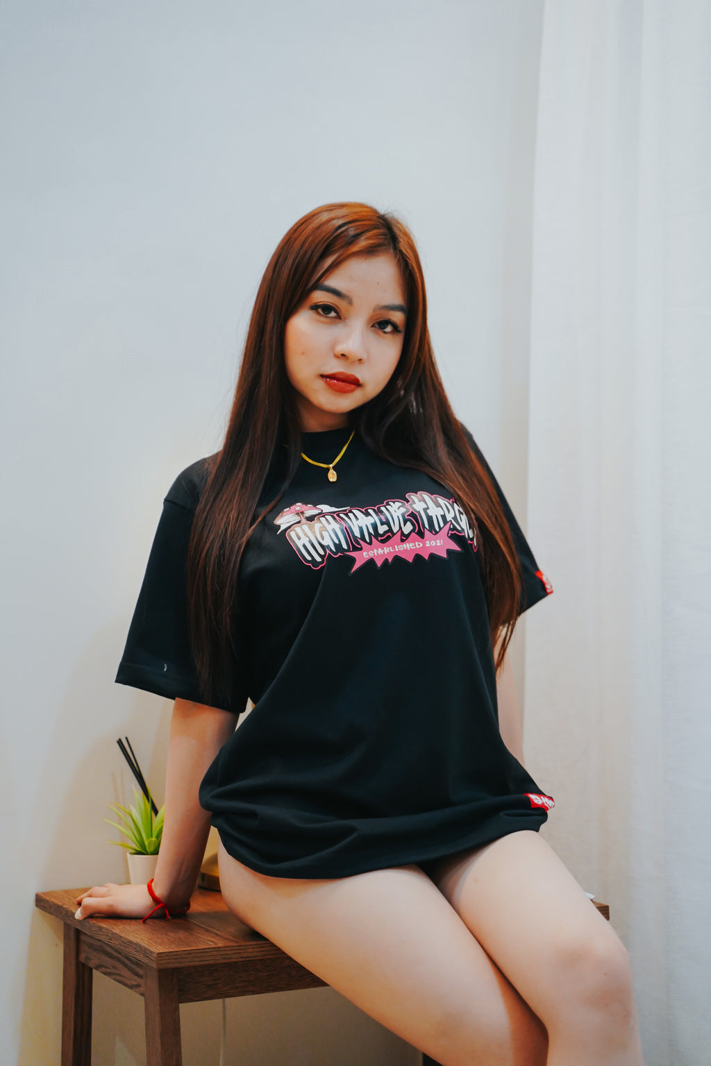 Graphic tee with stylized lettering and small mushroom detail in streetwear design