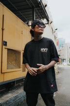 Black streetwear t-shirt featuring HVT logo on chest, clean minimal graphic design with bold lettering front print