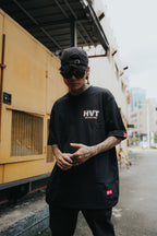 Streetwear tee featuring small HVT logo on front, simple bold lettering design for minimal urban fashion look