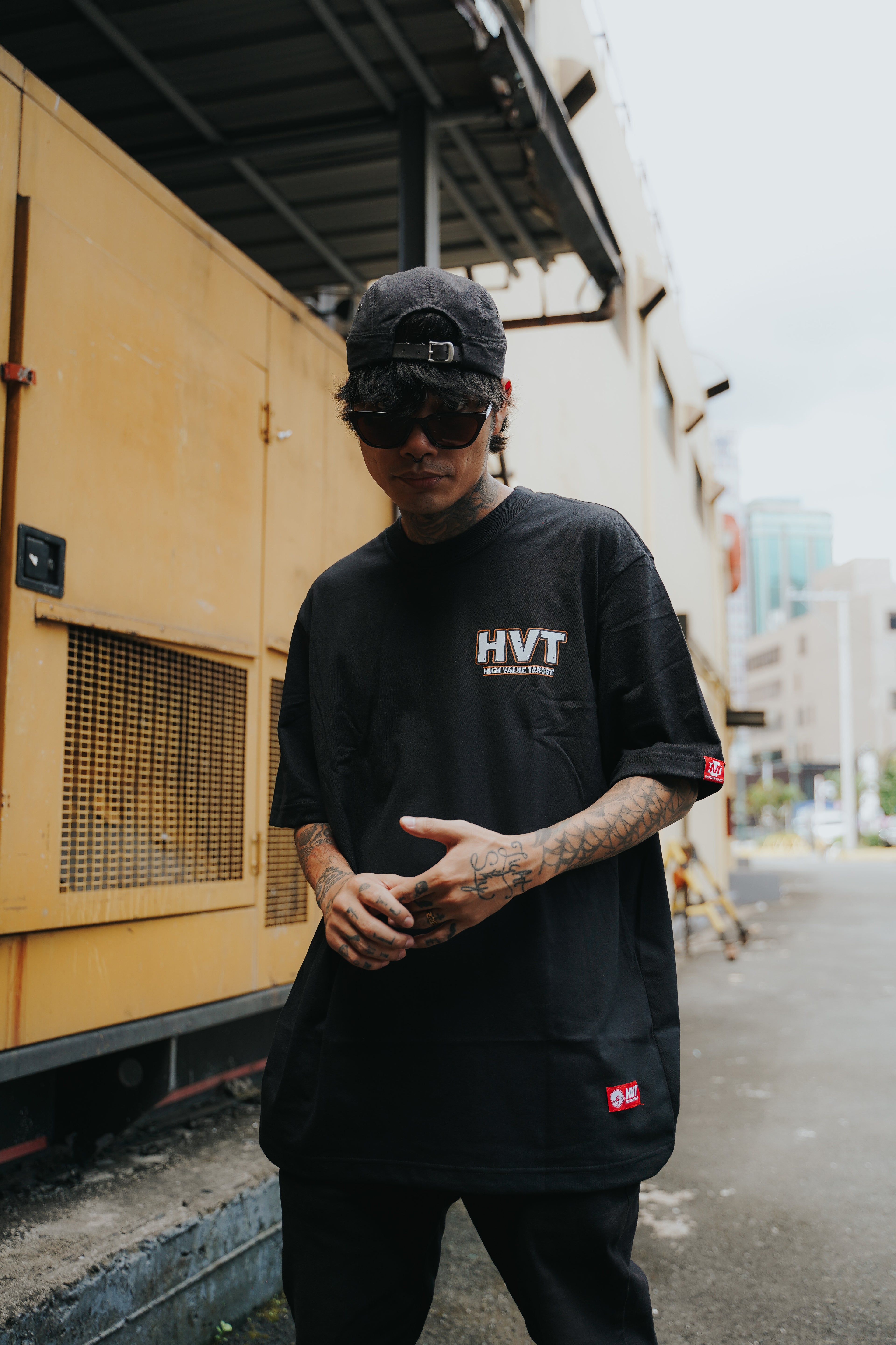 Streetwear tee featuring small HVT logo on front, simple bold lettering design for minimal urban fashion look