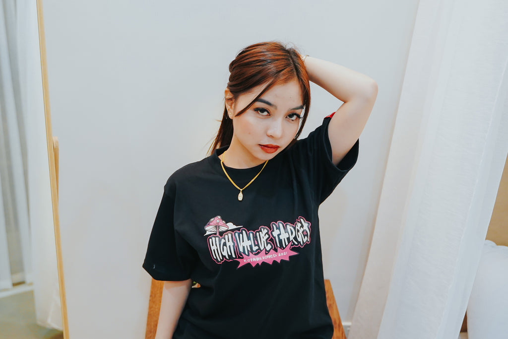 Black graphic T shirt with bold lettering and stylized streetwear typography