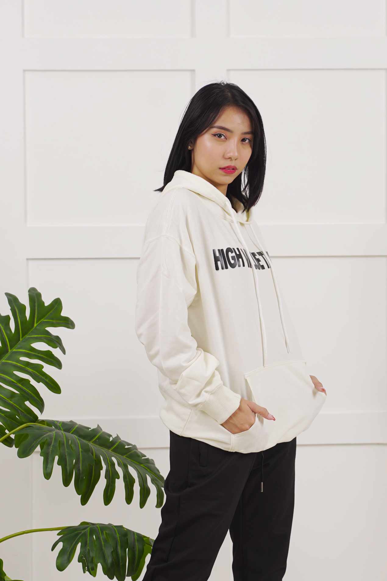 Cream fashion hoodie with subtle front graphic, modern streetwear piece featuring simple and clean design