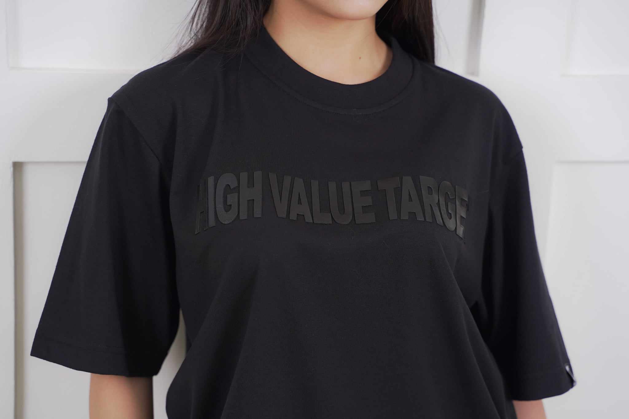 Black on Black T shirt with embossed text design for minimalist streetwear styling