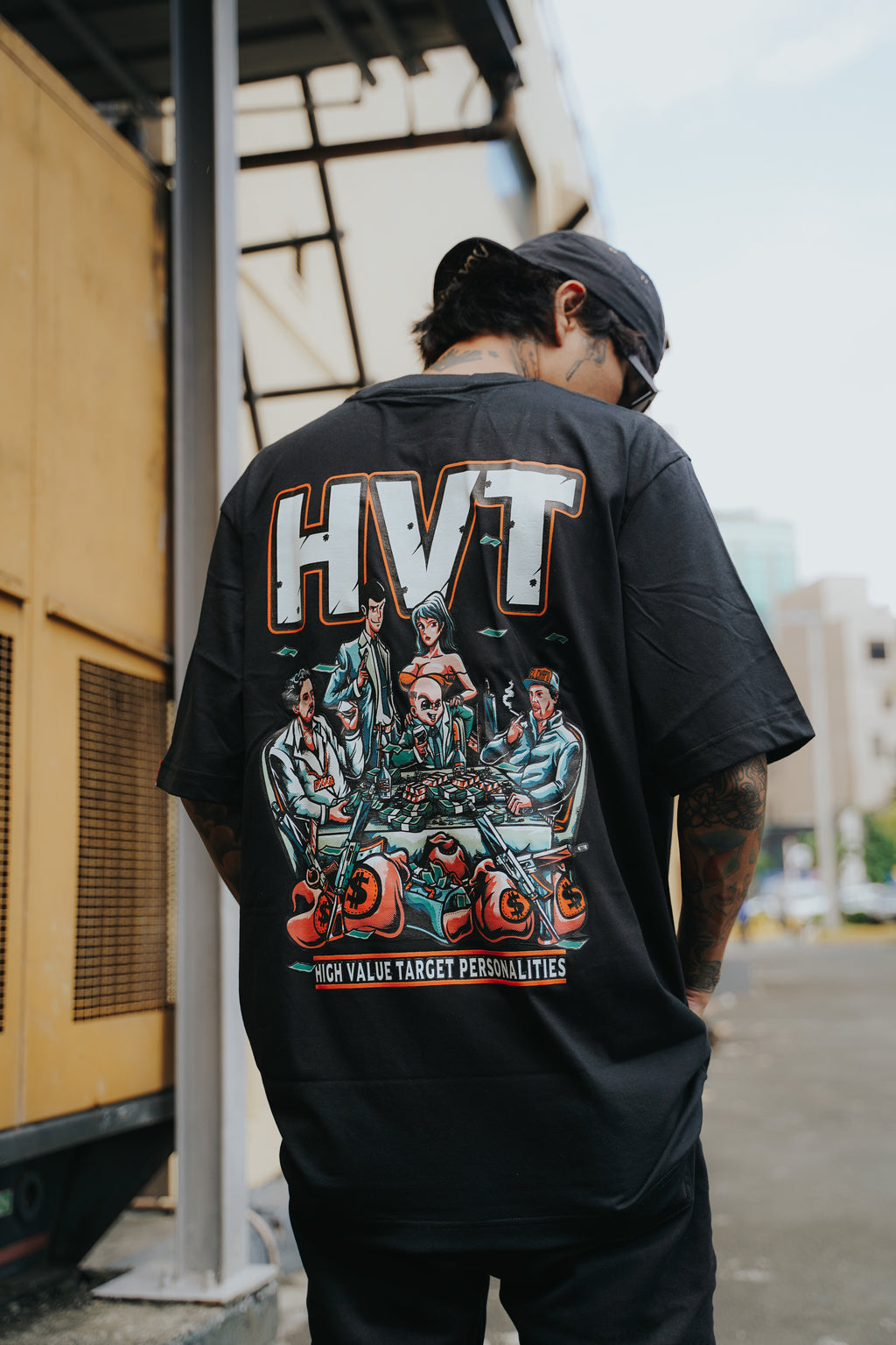 Graphic shirt showing anime-inspired group at table with piles of cash, modern streetwear style back design