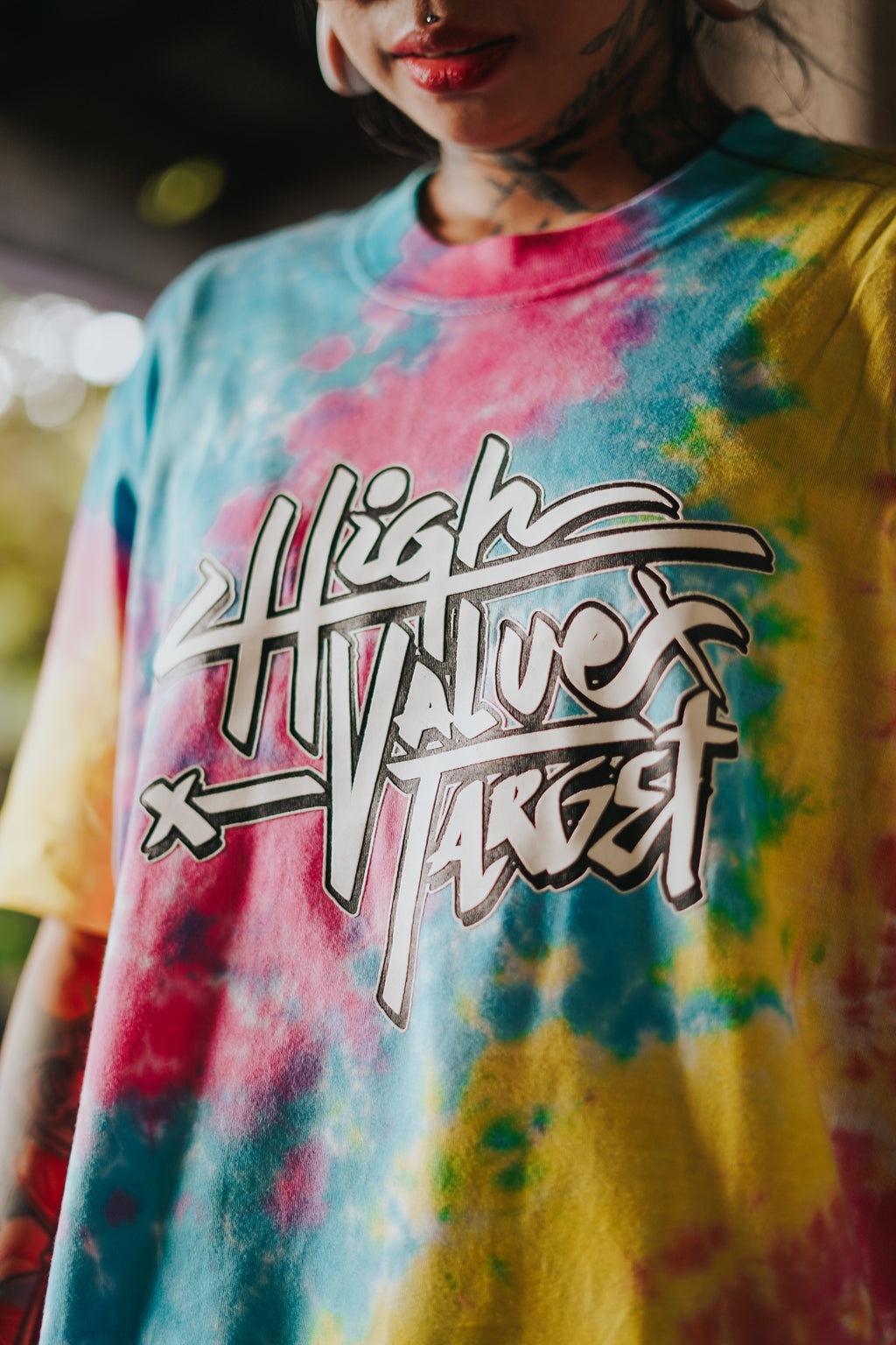 Colorful pastel tie dye shirt featuring High Value Target print on front, trendy streetwear piece with gradient pattern