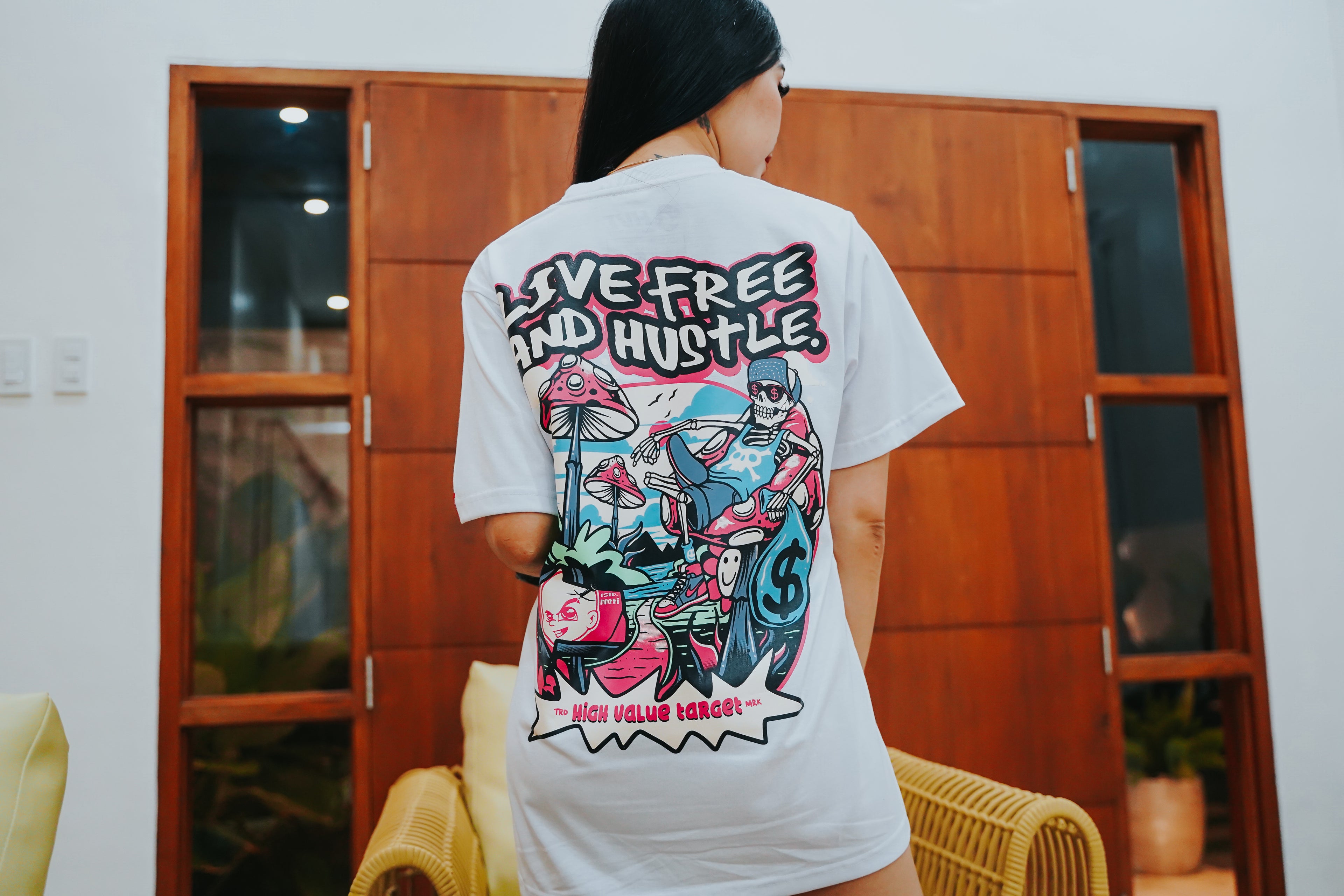 Stylish graphic shirt featuring skeleton chilling with cash and mushrooms, Live Free and Hustle message design